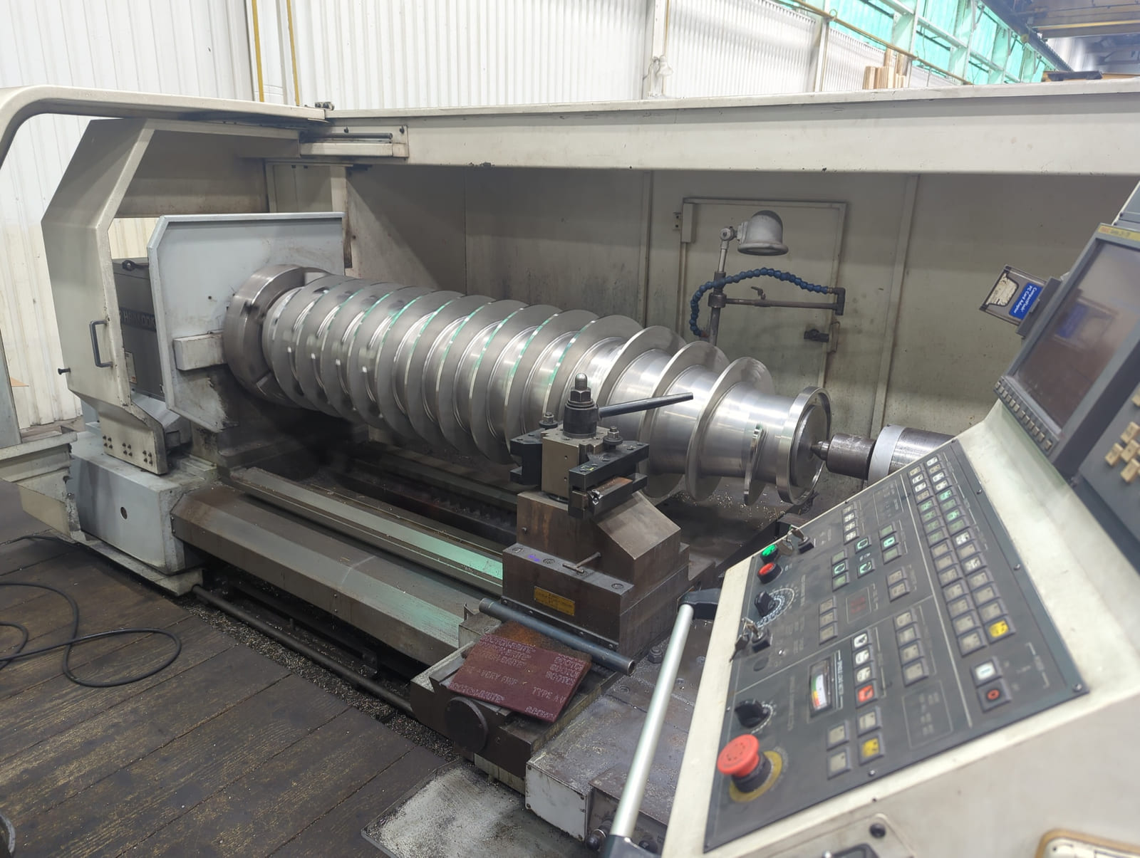 Large centrifuge screw undergoing CNC machining at HFW Industries