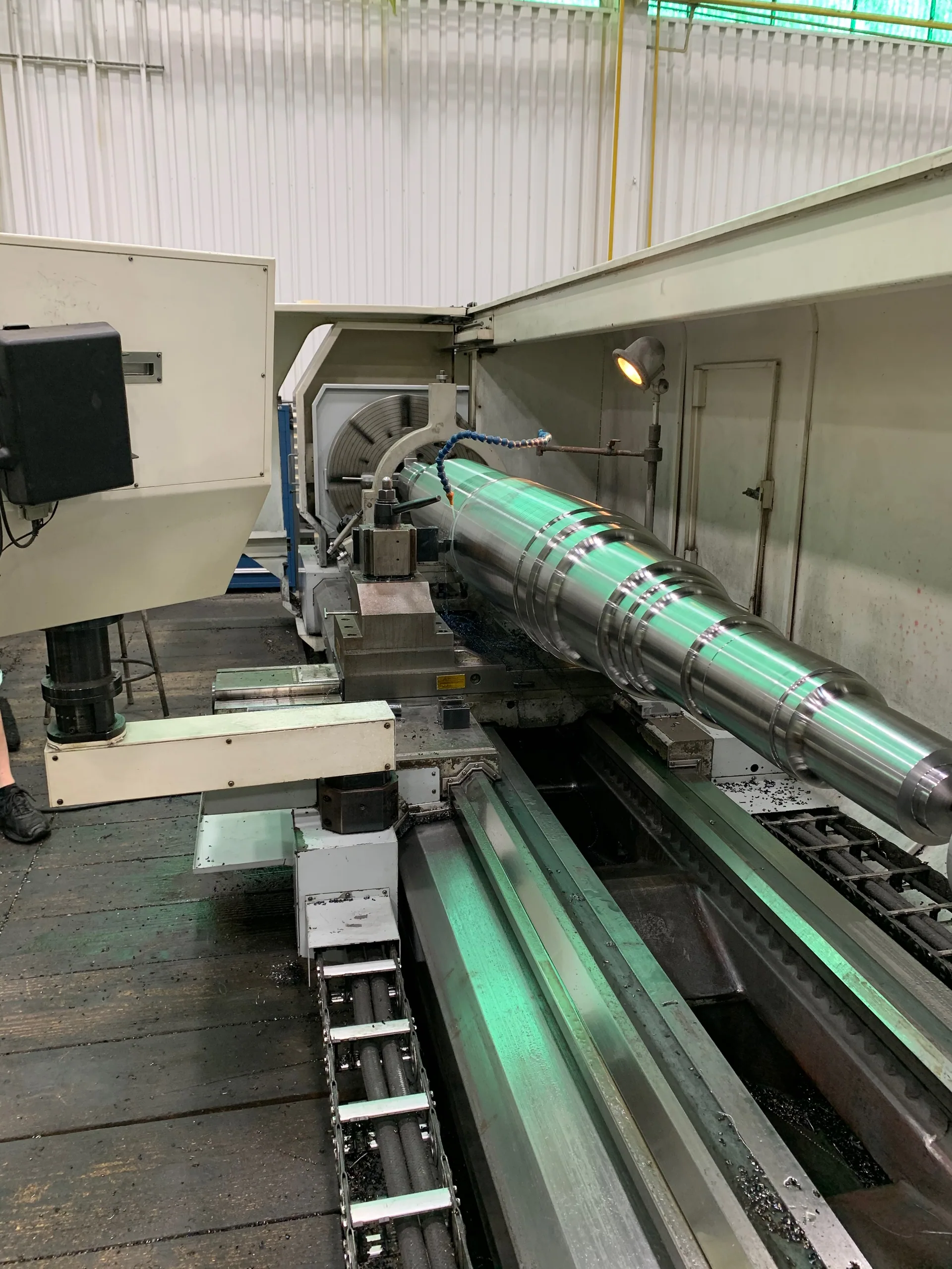 Shaft machining in a lathe at HFW Industries for power generation manufacturing