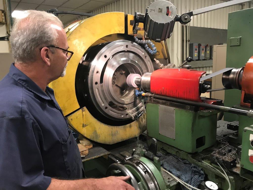 Machinist performing internal diameter grinding on a bore at HFW Industries