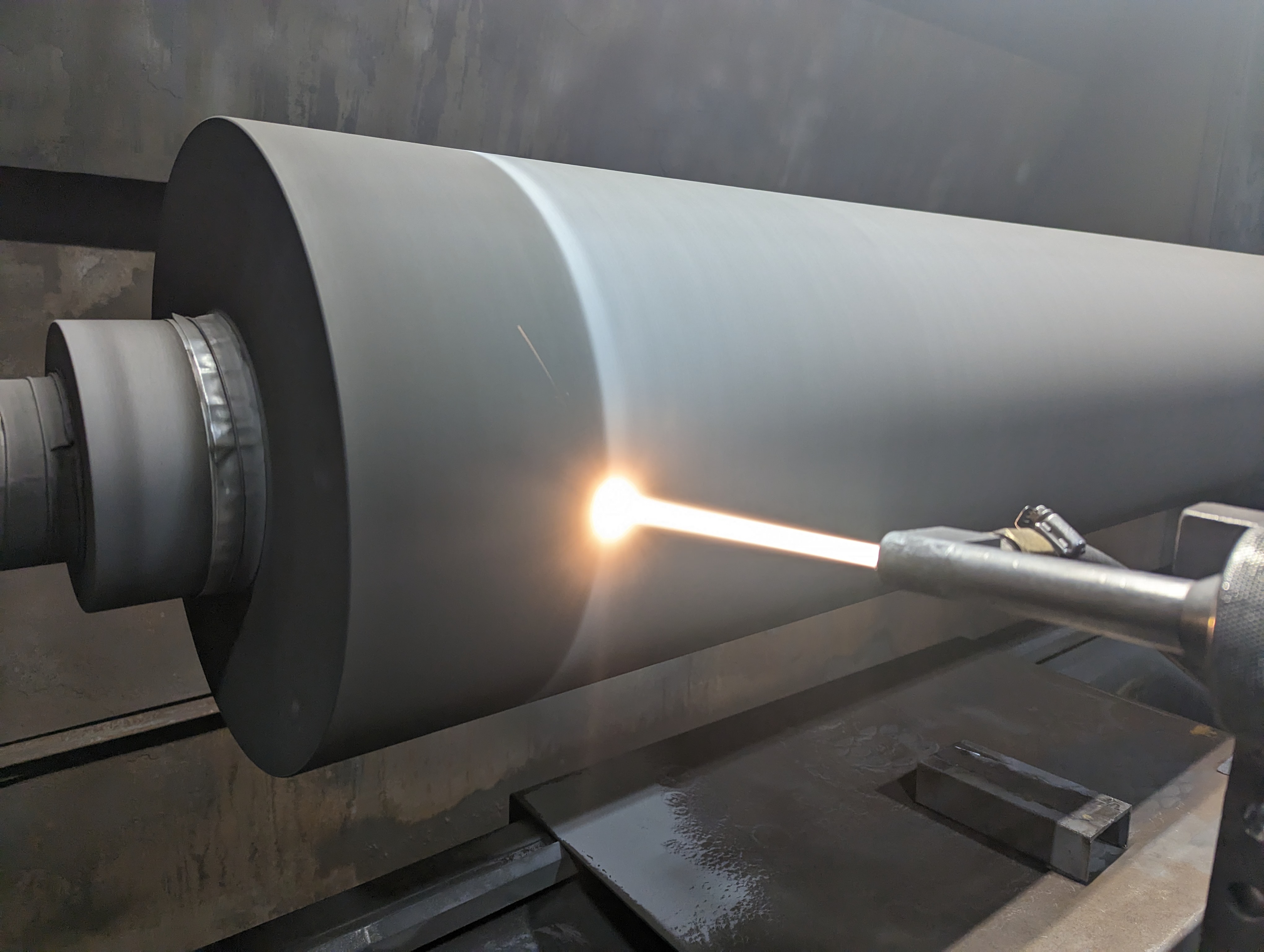 HFW Industries applying the HVOF process to a large roll for the paper industry.